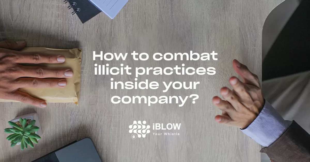 Two hands on a wooden table; one hand holding a brown envelope, the other gesturing with an open palm. There are a small plant, a notebook, and a laptop on the table, in na iBlow.eu article "How to combat illicit practices inside your company?"