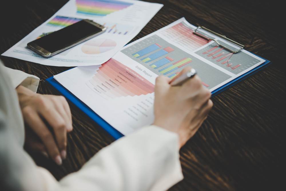 Person analyzing colorful data charts
