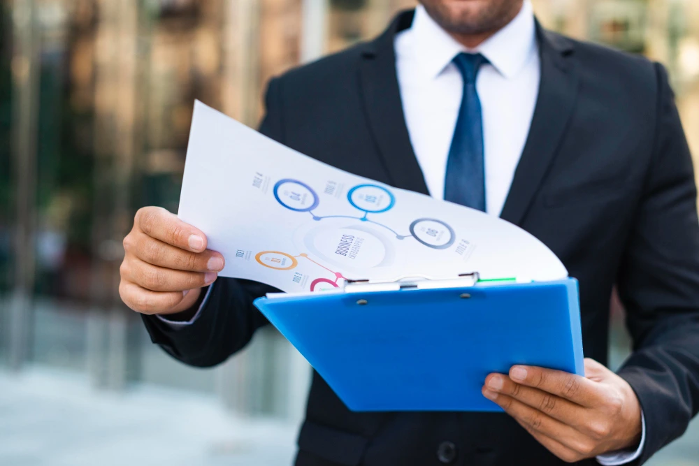 Businessman holding document and clipboard